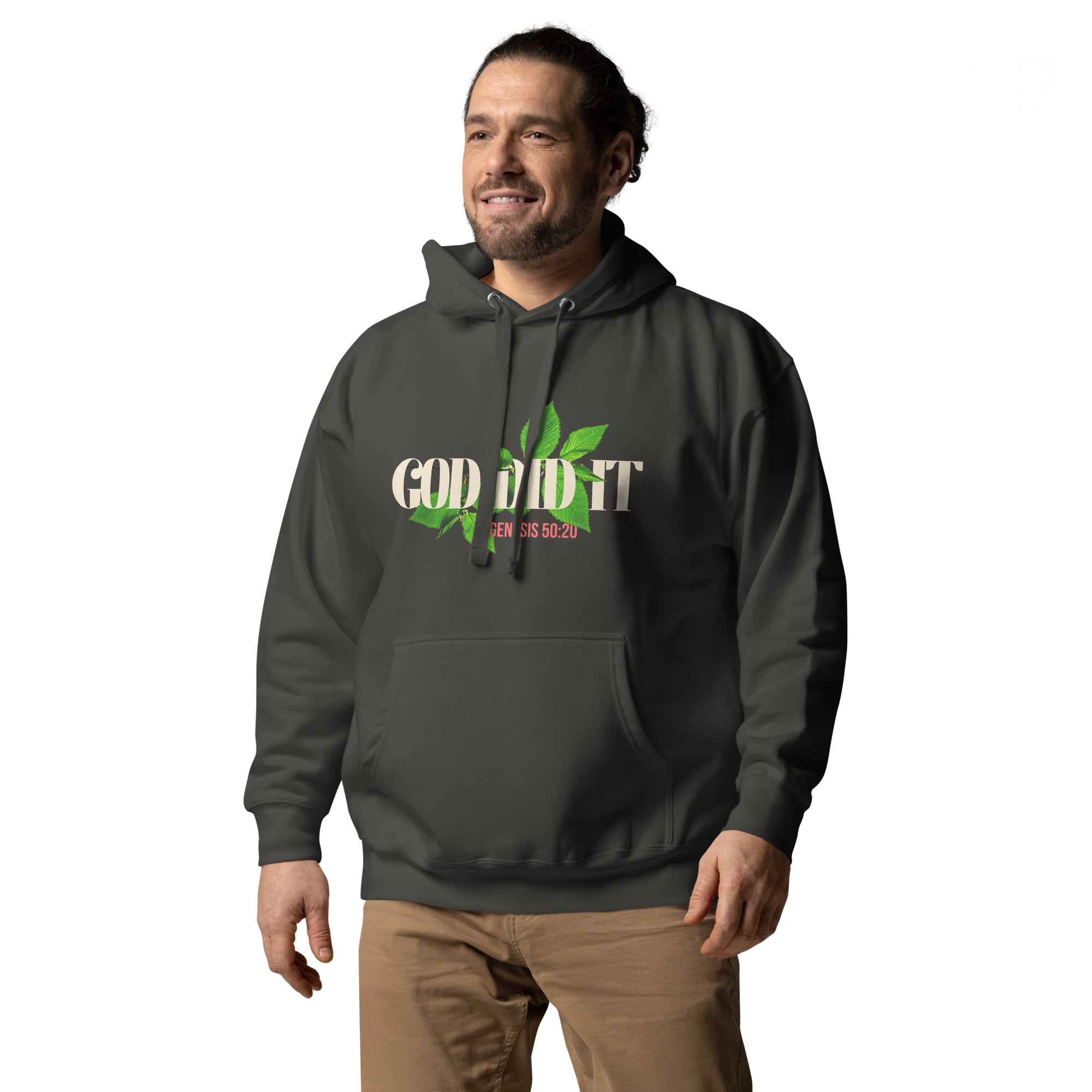 Man wearing a dark Christian faith-based hoodie with “God Did It” in large distressed letters and green vine design. Red “Genesis 50:20” detail under text. Comfortable, modern fit.