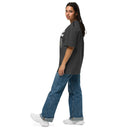 Woman walking in black 'Outside of Your Name' Christian T-shirt – relaxed oversized fit with bold scripture and fig vine artwork – Influence View
