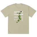 Eucalyptus green oversized Christian T-shirt with vertical white text reading “Outside of Your Name” and “nothing is the same.” Features trailing green vine design overlaid on text.
