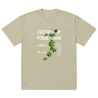 Eucalyptus green oversized Christian T-shirt with vertical white text reading “Outside of Your Name” and “nothing is the same.” Features trailing green vine design overlaid on text.