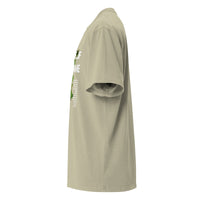 Side view of a eucalyptus green oversized tee showing the vertical front graphic and relaxed fit. Faith-based message with vine artwork partially visible from side angle.