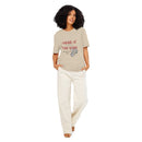 Woman wearing tan 'Outside of Your Name' tee – organic-inspired Christian statement shirt with red text and fig illustration – Influence View apparel